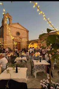 a group of people sitting at tables in front of a building at Casa Vacanze Matilde Marzamemi in Marzamemi +43 photos