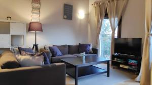 uma sala de estar com um sofá e uma mesa em Apartamentos GO - Tordesillas House nas Tordesilhas