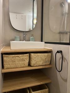 a bathroom with a sink and a mirror at Duplex FACE AU LAC à 600 mètres de la mer in Six-Fours-les-Plages