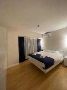a bedroom with a large bed and a window at Orbi city Panorama towers in Batumi