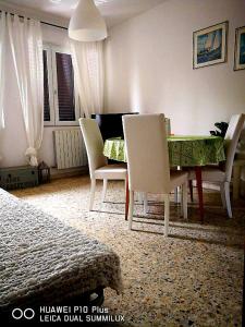 sala de estar con mesa de comedor y sillas en La Villetta Aeroporto Galilei, en Pisa