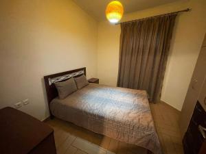 a bedroom with a bed and a large window at Arachova Dream in Arachova