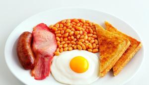 a plate of breakfast food with eggs bacon beans and toast at LUXURY YACHT STAY "White Dove" sleeps 6 in Gibraltar