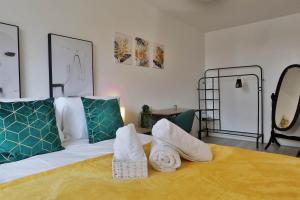 a bedroom with a bed with towels on it at The Old Kent Hideaway by TTLG Stays in London