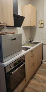 a kitchen with a stove and a stove top oven at appartement Gérardmer proche lac et centre ville in Gérardmer