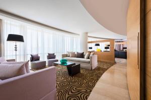 a living room with two couches and a table at Le Meridien Cairo Airport in Cairo