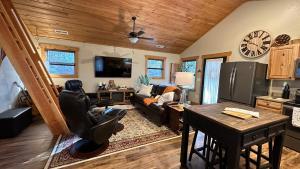 a living room with a couch and a table at The Cabin at Merrywoods in Murphy