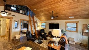a living room with wooden ceilings and a loft at Twinn Peaks Beautiful Modern Mountain Cabin Retreat-Cozy-Secluded-WiFi-Pets in Murphy