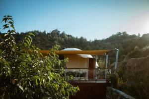 a house with a yellow roof sitting on top of a hill at Agros Glamping Boutique in Agros