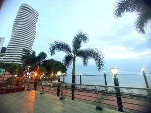 vistas al océano y a un edificio con palmeras en Puerto Santana suite, en Guayaquil