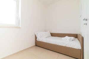 Un pat sau paturi într-o cameră la Moments by MONHOLIDAY