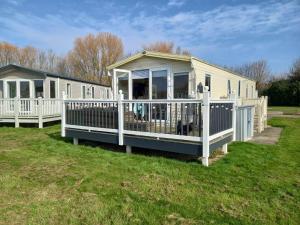 a mobile home with a porch and a deck at Cleethorpes beach haven site in Cleethorpes