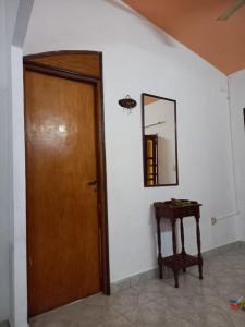 a room with a door and a mirror and a table at Flia Perez Derrache in Ituzaingó