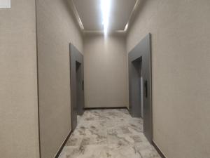 a hallway with two doors and a tile floor at Spacious Apartment in Yerevan, CENTRE in Yerevan