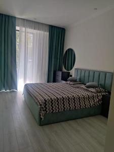 a bedroom with a bed and a large window at Spacious Apartment in Yerevan, CENTRE in Yerevan