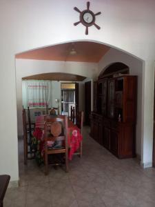 a dining room with a table and a clock on the wall at Flia Perez Derrache in Ituzaingó