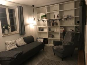 a living room with a couch and a chair at Haus Finchen - Alte Näherei in Hückelhoven