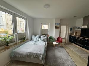 a bedroom with a large bed and a kitchen at Near Holstentor modern apartment near the center with wifi in Lübeck