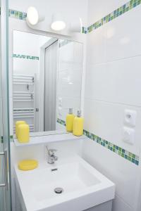 a white bathroom with a sink and a mirror at Centre port,vue panoramique,Clim,Balcon,wifi in Cap d'Agde +41 photos