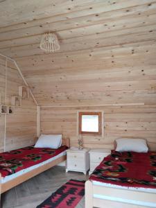 a log cabin with two beds and a window at Katun Siska Medna Dolina in Berane