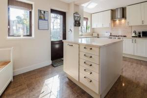 a kitchen with white cabinets and a counter top at Good Night Sleep 25 mins from London Bridge and Gatwick Airport in Farnborough