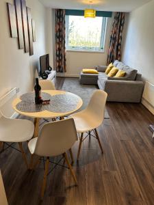 a living room with a table and chairs and a couch at The Landmark Brierley Hill in Dudley