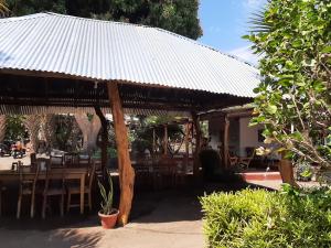 a wooden pavilion with a table and chairs and a table at Playa Casa Nohelia in Santo Domingo