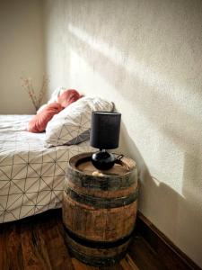 a bedroom with a bed and a barrel with a lamp at Haus Fabjerg in Lemvig