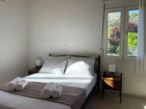 a bedroom with a bed with two towels on it at Garden Ηouse 3 in Plomari