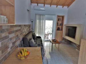 a living room with a bowl of bananas on a table at Garden Ηouse 3 in Plomari