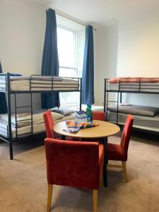 a room with a table and chairs and bunk beds at Eden Quay Guesthouse Private Rooms in Dublin