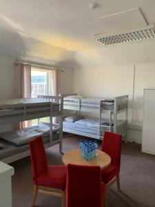 a room with two bunk beds and a table and chairs at Eden Quay Guesthouse Private Rooms in Dublin