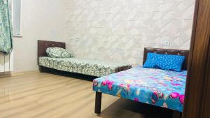 a room with a bed and a couch in it at Key Explore Hostel Hotel in Baku