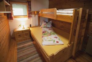 1 Schlafzimmer mit 2 Etagenbetten und einem Schreibtisch in der Unterkunft Urlaub im Blockhaus in Diex