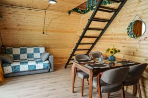 a room with a table and chairs and a ladder at Villa Hillside Gudauri in Kʼumlistsʼikhe