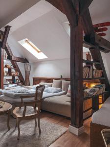 a bedroom with a bed and a couch and a table at Blue Lotus Apartments in Bratislava