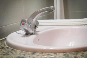 a bathroom sink with a faucet on top of it at Hotel Neptuno in Oropesa del Mar +43 photos