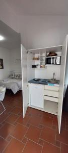 a kitchen with a counter and a sink in a room at Bed And Breakfast A CASA DI LEO in Tarquinia