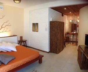 ein Schlafzimmer mit einem Bett und ein Wohnzimmer in der Unterkunft Pousada Residencia Duna Paraiso in Maceió