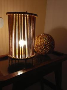 una lámpara sobre una mesa junto a un jarrón en Pousada Residencia Duna Paraiso, en Maceió