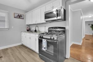 a kitchen with a stainless steel stove and a microwave at GoodLiving: Serenity in Atlanta