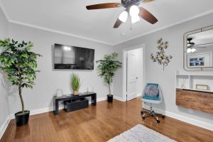 a living room with a ceiling fan and plants at GoodLiving: Serenity in Atlanta