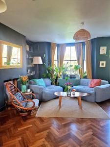 uma sala de estar com um sofá e uma mesa em Charming bedroom in artist studio em Londres