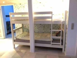 a couple of bunk beds in a room at Airy, cosy guesthouse in Mariager