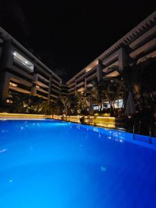 a large swimming pool in front of a building at night at Sheraton Ocean 503 - Private Apartments in Cairo