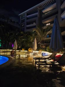 a pool with chairs and umbrellas next to a building at Sheraton Ocean 503 - Without Pool access in Cairo