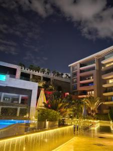a view of a building and a pool at night at Sheraton Ocean 503 - Private Apartments in Cairo