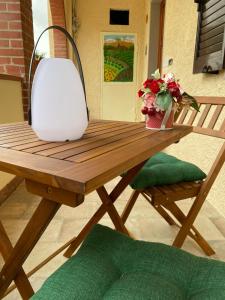 a picnic table with a chair and a vase of flowers at Casa Vacanze Podere San Giusto Volterra in Volterra