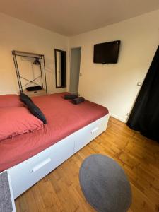 a bedroom with two beds and a flat screen tv at Beau studio plein centre ville in Beauvais