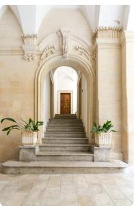 a staircase in a building with two potted plants at Appartamenti San Matteo in Lecce